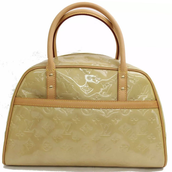 Don't care for the bag charm, but I LOVE the color of the patina on this  bag. Louis Vuitton Speedy Bag